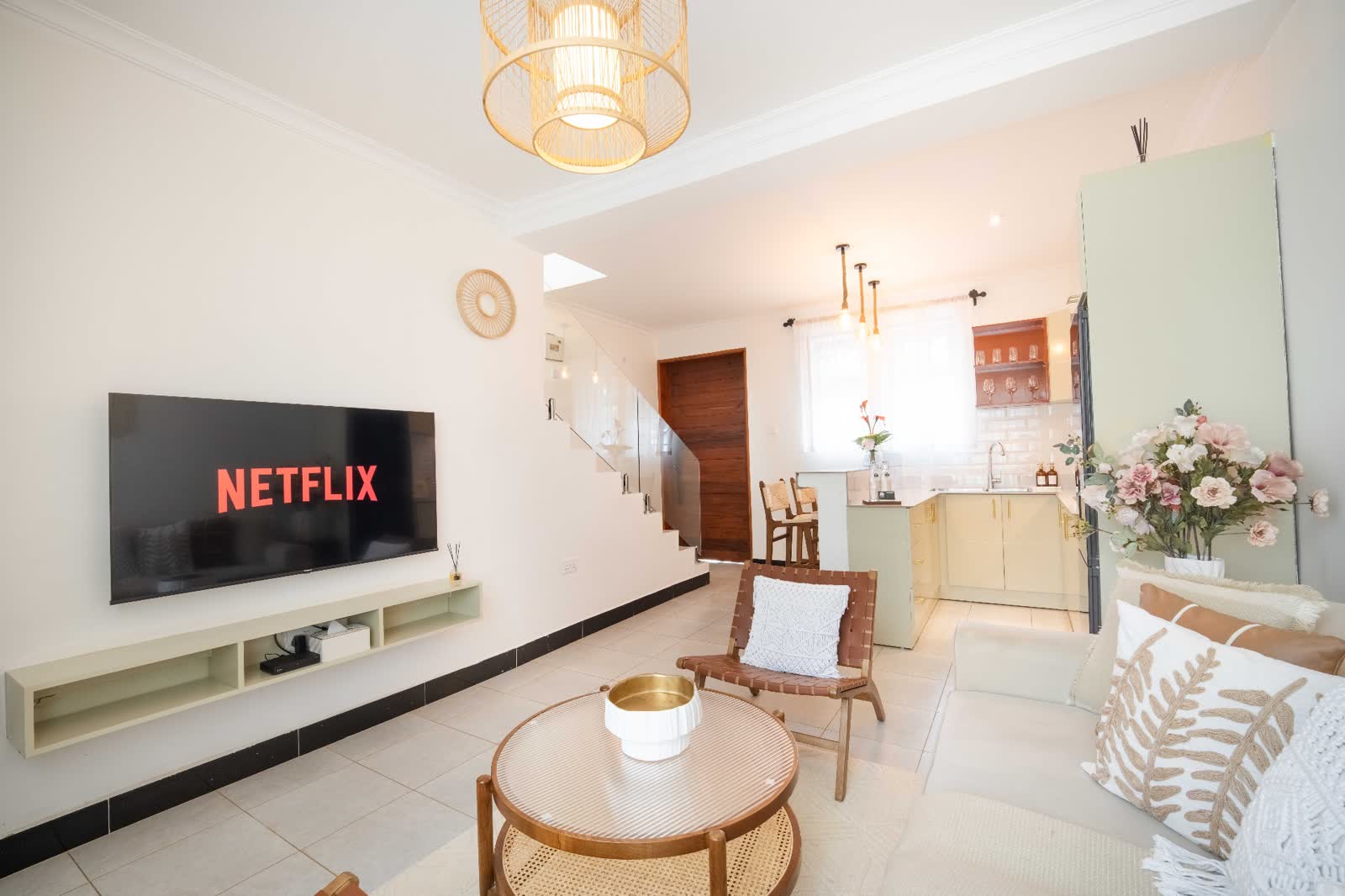 Ruby apartment lounge with smart TV and kitchen view